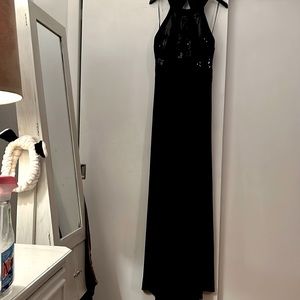 sequined halter gown.Sunburst-style straps in the back